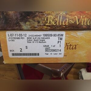 Woman’s Bella-Vita multi colored snake print slip on shoes.
